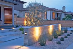 an outdoor garden with lights on the side