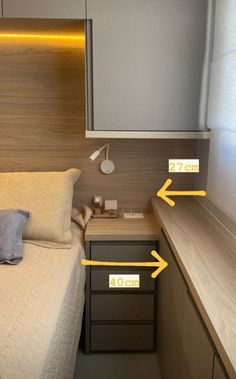 a bed with two yellow arrows pointing to the headboard and night stand next to it