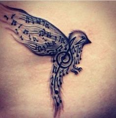 a bird with musical notes on it's back side tattoo is shown in black and white