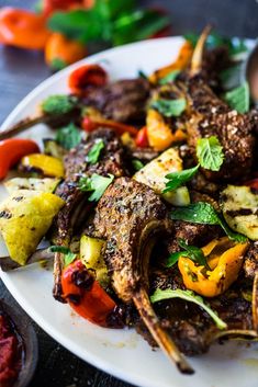 a white plate topped with meat and veggies