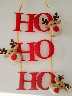 two christmas decorations hanging on a wall with the word ho hoo spelled in red