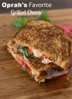 a grilled cheese sandwich sitting on top of a wooden cutting board