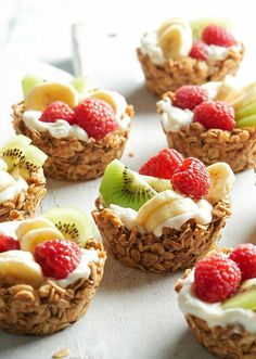 some fruit and yogurt cups are arranged on a table