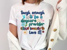 This "Tough Enough to Be a Daycare Provider, Crazy Enough to Love It" shirt is the perfect way to celebrate the hardworking and dedicated daycare providers who make a difference in children's lives every day. Featuring a fun and proud design, this daycare provider shirt captures the unique blend of toughness and love required for the job. Made from soft, comfortable fabric, it's ideal for daily wear at work, school events, or casual outings. Whether you're a childcare worker yourself or looking Daycare Shirts, Daycare Gifts, Daycare Providers, To Love, It Shirt, It Funny, Retro Sweatshirts, Toddler Mom, School Events