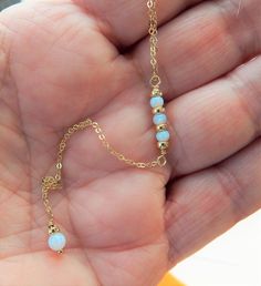 "OPAL LARIAT NECKLACE Our Opal Lariat Necklace features dainty white lab opals. Simple and elegant. Photos do not do this opal justice! IT'S IN THE DETAILS ✦ 14K Gold Filled, Sterling Silver or Rose Gold Filled Chain and all components ✦ White Lab Opals ( 3mm & 4mm) ✦ Shown at 17\" + 3\" Chain Drop To see ALL Lariat Necklaces, click here: https://www.etsy.com/shop/SimpleAndLayered?ref=seller-platform-mcnav&section_id=16420368 ✦ Handmade to order, please allow 3-5 days for us to make your Single Strand Long Drop Jewelry Gift, Round Beads Single Strand Lariat Necklace As Gift, Lariat Necklace With Round Beads As Gift, Wire Wrapped Dangle Lariat Necklace As A Gift, Dangle Wire Wrapped Lariat Necklace Gift, Gift Lariat Necklace With Wire Wrapped Dangle, Gift Wire Wrapped Dangle Lariat Necklace, Gemstone Dangle Lariat Necklace As Gift, October Birthstone Necklace