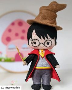 a stuffed toy with a hat and glasses on it's head, holding a wand