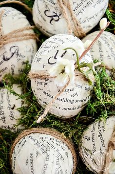 some white balls with writing on them are tied up and ready to be used as decorations