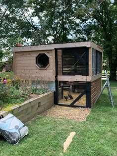 a chicken coop in the middle of a garden