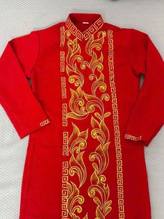 High-quality Vietnamese Dress for Men. It is very well-made with high-quality fabric with embroidered patterns. Some information about the product Ao Dai Vietnam: Material: Tuyet mua ( a popular fabric for making ao dai) Style: Traditional Pattern: Gold hoa van Length Ao Dai:  Approximately 42 Inches  NOTE: The dimensions listed in the size chart will be used to create the ao dai. Please select your size based on the table, and if you're having trouble finding your size, don't hesitate to write me; I'll be pleased to assist you.   There might be some chalk/ pen writings on the fabric because it is brand new, unwashed ao dai. These marks can be washed away easily. POLICY:  + I don't accept cancellations, returns, or exchanges. + In some circumstances, I can exchange it for a fee and buyers Traditional Fitted Cotton Ao Dai, Long Sleeve Kurta With Gold Embroidery For Traditional Ceremonies, Ceremonial Embroidered Ao Dai With Long Sleeves, Gold Embroidered Fitted Kurta For Traditional Ceremonies, Fitted Long Sleeve Kurta With Gold Embroidery, Traditional Embroidered Ao Dai For Formal Occasions, Men Ao Dai, Ao Dai Men, Ao Dai Vietnamese