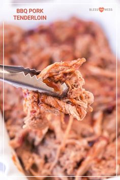 a spoon full of pulled pork on top of a casserole dish with sauce