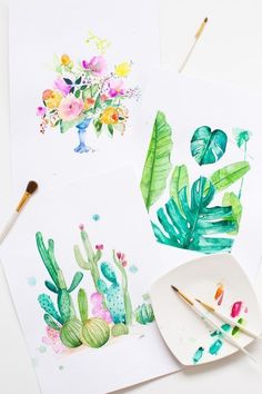 some watercolors are being used to paint flowers and cactuses on white paper