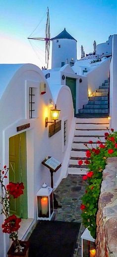 an image of a house with stairs and flowers