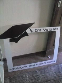 a graduation cap on top of a sign in front of a door that says dra maria lines