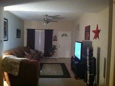 a living room filled with furniture and a flat screen tv