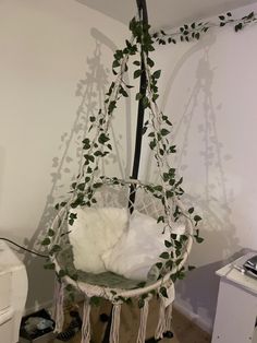 a white hammock hanging from a tree in a room