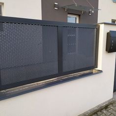 a wall mounted mailbox on the side of a building