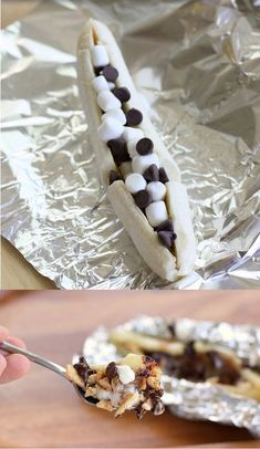 a banana with marshmallows and chocolate chips in it on aluminum foil,