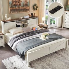 a bedroom with a bed, dressers and tv in it's center area