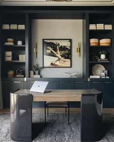 an office with built in bookshelves and desk