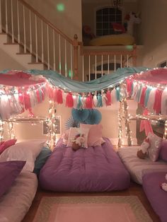 there is a bed with lights on the ceiling and some pillows in front of it