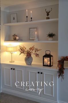 a white shelf with candles and flowers on it