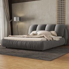 a large bed sitting on top of a wooden floor