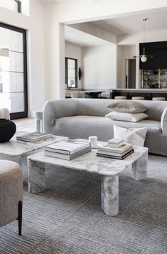 a living room with couches and tables in it