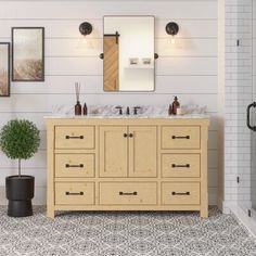 a bathroom with two sinks and mirrors on the wall