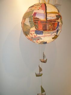 a mobile made out of quilts hanging from a wall