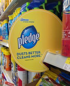 a pile of pledge products on display in a grocery store with the price cut off