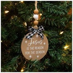 a wooden ornament hanging from a christmas tree with the words jesus is the reason for the season