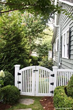 a white gate in front of a house