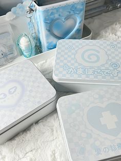 four white and blue boxes with designs on them sitting on a furnishing area