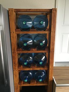 a wooden shelf filled with lots of blue plastic bowls on top of eachother