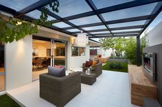 an outdoor living area with couches and chairs