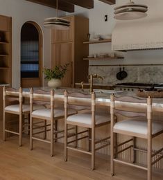 a kitchen filled with lots of counter top space next to a dining room table and chairs