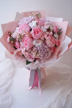 a bouquet of pink flowers on a white surface