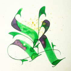 the letter k is painted in green and purple