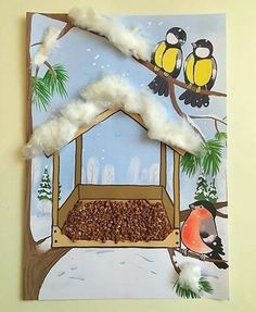 a bird feeder made out of paper with birds perched on the tree branches and snow