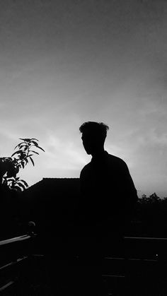 a man sitting on a bench in the dark