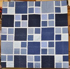 a blue and white quilt is on display