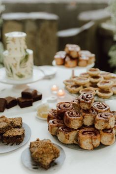 a table topped with lots of pastries and desserts