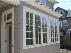 the side of a house with white windows