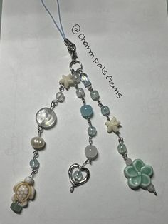 a paper with some charms attached to it