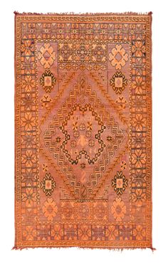 an orange and brown rug with geometric designs on the front, in different colors and shapes