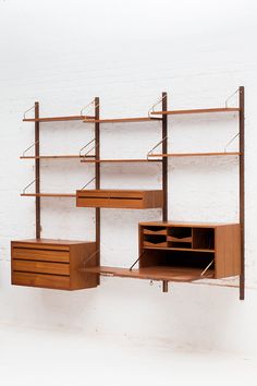 a wall mounted shelving unit with drawers and shelves