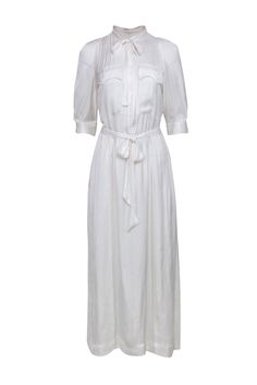 Embrace the sun-kissed allure of summer whites with Zadig & Voltaire. Crafted with exquisite attention to detail, this timeless piece embodies a fusion of style and comfort with its crop sleeves and quarter button front. Throw on your sandals and a bikini underneath and be ready to hit the beach! Size S 100% Polyester Unlined Quarter button front Crop sleeve Two button front pockets Smocked middle back Attached waist sash Bust 42" Waist 47" Shoulder to hem 54.5" Sleeve length 16" Classic Summer Daywear Dress, Classic Summer Day Dress, Classic Beach Dresses For Spring, Classic Spring Dress For Vacation, Classic Spring Vacation Dress, Formal White Viscose Dress, Elegant White Daytime Dress, White Feminine Dress With Relaxed Fit, Summer Formal Dresses With Relaxed Fit