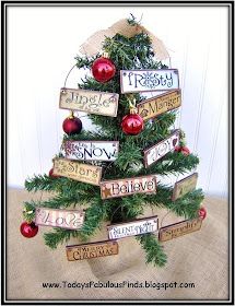 a small christmas tree decorated with wooden signs