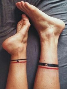 two people with matching wristbands sitting on a bed