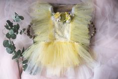 This is a listing for a romper/dress decorated with tulle ruffles with pearls and lemon/flowers element that could be removed before washing.  Sizes: The size is pretty flexible, it ties on the waist back area and it has an elastic.               12-18 month             Ready to ship! The romper matches this headband https://www.etsy.com/listing/1203933580/rts-lemon-flower-crown-sitter-lemon?click_key=dc51d9bcf66ad9e710f0e9069d3a2e0a9fe3ec52%3A1203933580&click_sum=0a651101&ga_search_query=lemon&ref=shop_items_search_1&sts=1 All used materials are new. All items are made with care in a smoke/pet free environment. I would like to invite you to Your Dream Pix LLC VIP customers group!  Please, join us for all news and updates from my shop, new products, SALES and discounts.  https://www.facebo Whimsical Ruffled Tutu Dress For Spring, Spring Fairy Dress With Ruffles For Dress-up, Whimsical Ruffled Tutu Dress For Summer, Whimsical Summer Tutu Dress With Ruffles, Cute Tulle Fairy Dress With Ruffles, Summer Fairy Dress With Ruffles For Dress-up, Fitted Ruffle Fairy Dress For Dress-up, Fitted Fairy Dress With Ruffles For Dress-up, Whimsical Ruffled Tutu Dress For Wedding